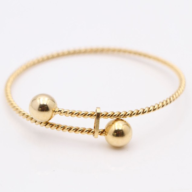 Brazalete sogueado ajustable de oro...