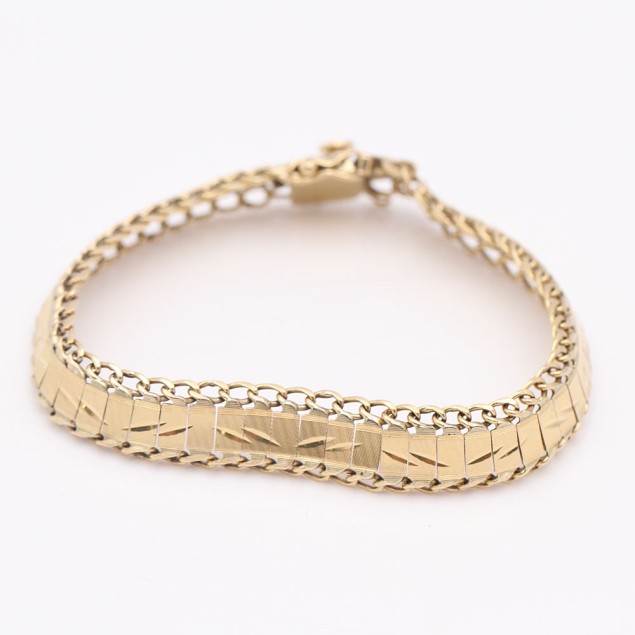 Pulsera articulada labrada de oro de...