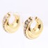 Boucles d'oreilles creuses en or avec zircones d'occasion