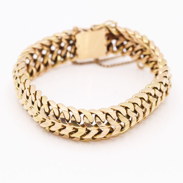 Pulsera barbada doble maciza de oro...