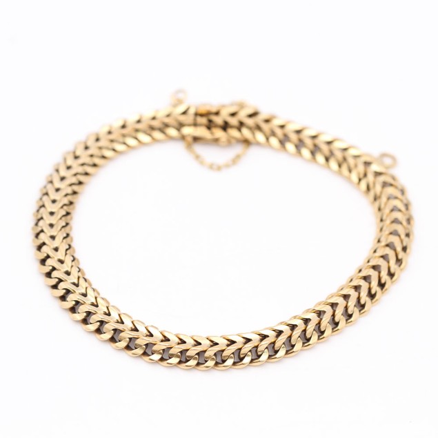 Pulsera barbada doble maciza de oro...