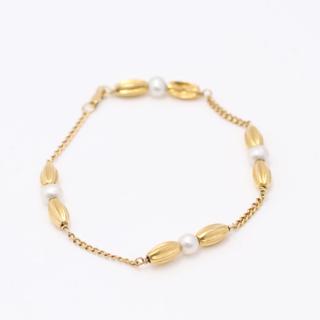 Pulsera barbada de oro 18k con perlas...